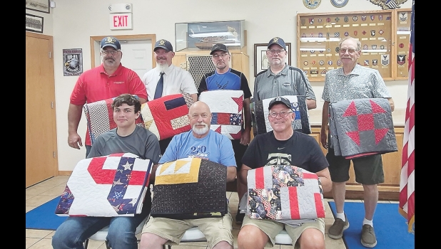 Veterans receiving Quilts of Valor at the Manly American Legion on August 9 included (front row, from left) Specialist E-4 Hunter Fellin (U.S. Army), Corporal E-4 Bryan Thenhaus (U.S. Marines), CMSGT E-9 Michael Reindl (U.S. Air Force), (back row) E-6 Staff Sergeant Jason Whitehurst (Army National Guard), E-6 Staff Sergeant Neil Wheeler (U.S. Army and U.S. Navy), Senior Airman Scott Heagel (U.S. Air Force), Senior Airman E-4 Devin Broerman (U.S. Air Force) and E-4 Rex Taylor (U.S. Army).