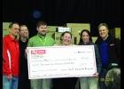 Brad and Angela Wright (center) are shown accepting a check for $12,500 on behalf of Worth County Community of Promise from Post Consumer Brands in St. Ansgar on Saturday, November 9. 