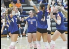 The Vikings celebrate consecutive ace serves during set two on Thursday night against Lake Mills.