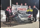 The group traveling 500 miles included (from left) Heather Palmer and Chris Palmer, who led the group, along with Hayden Olson, Russ Olson,Tim Charlson, Mike King and Mike Peterson. They are pictured with Nick Keller’s snowmobile.